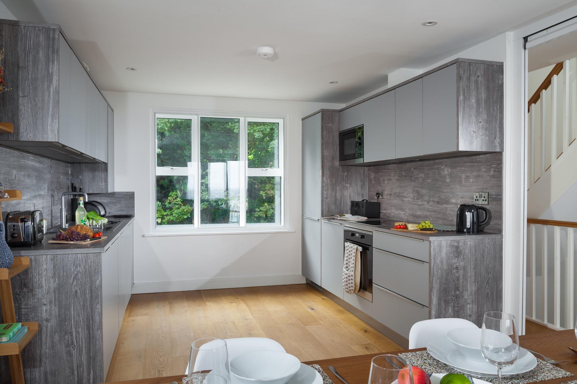 Modern and stylish, the kitchen is a great space to prepare beach picnics or cook delicious dinners.