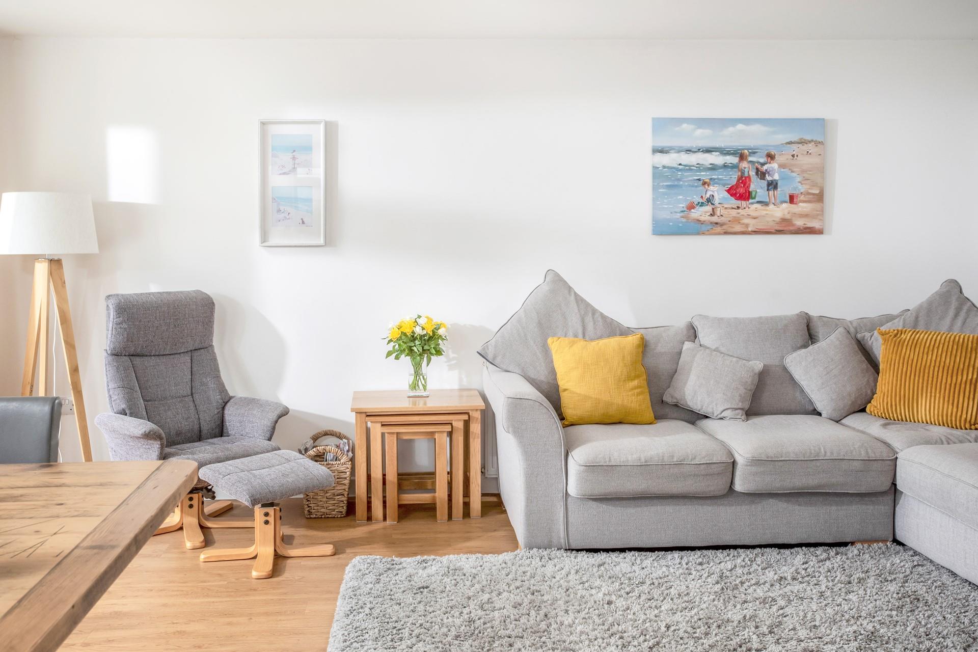 Stylishly decorated, the sitting room offers a space to relax and unwind after beach days.