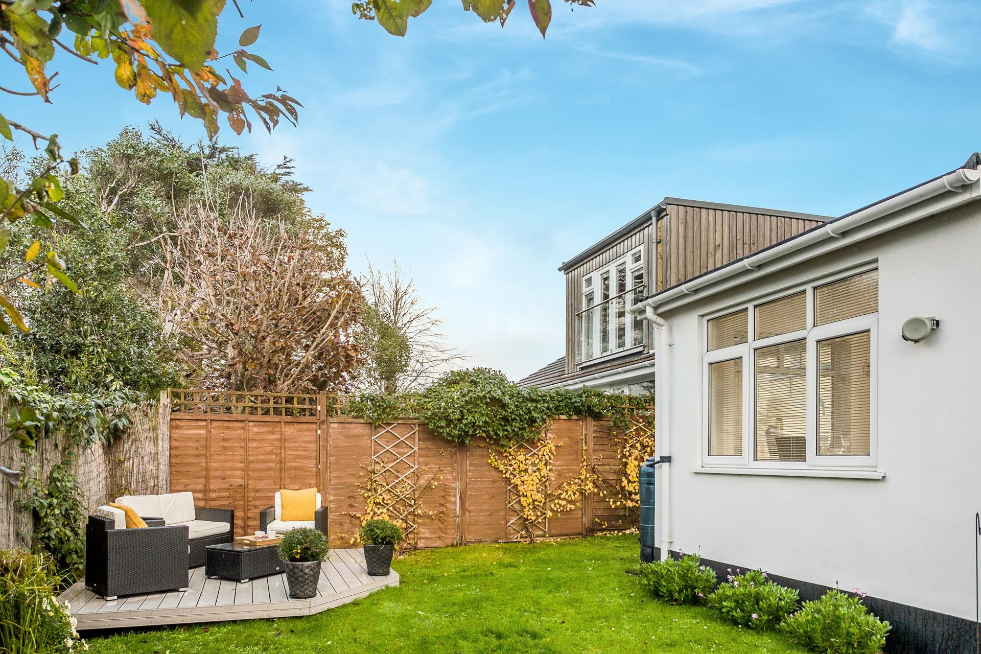 Soak up the sunshine on the outdoor rattan furniture in the garden.