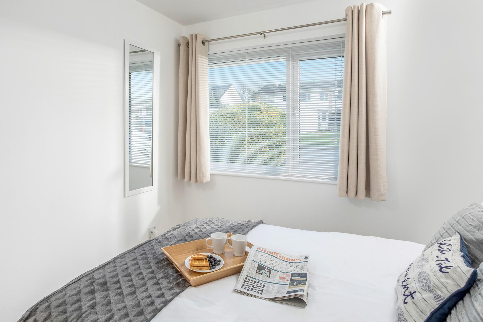 Open the curtains to check the day's weather and make a plan for the day.