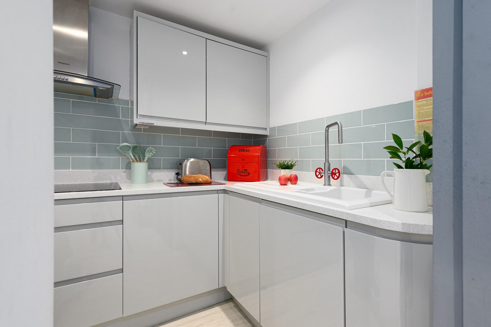 Modern and sleek, the kitchen has all you need for preparing and cooking meals.