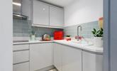 Modern and sleek, the kitchen has all you need for preparing and cooking meals. - Thumbnail Image