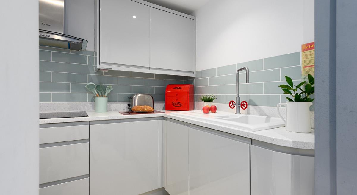 Modern and sleek, the kitchen has all you need for preparing and cooking meals.