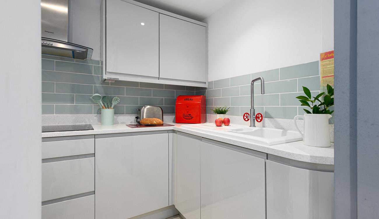 Modern and sleek, the kitchen has all you need for preparing and cooking meals.