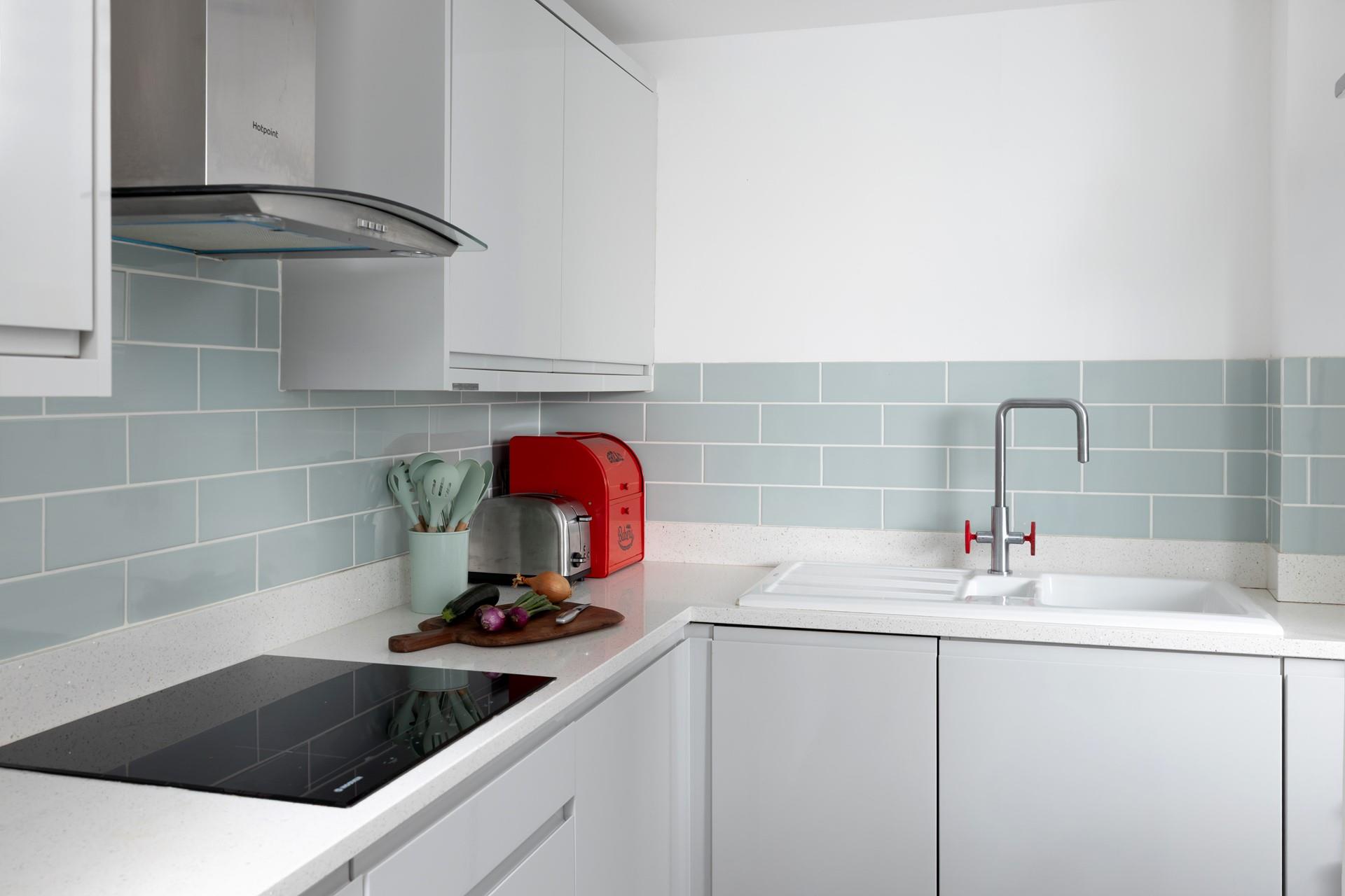 Modern and sleek, the kitchen has all you need for preparing and cooking meals.