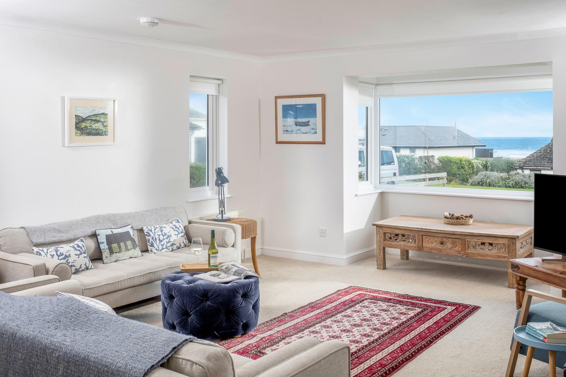 Enjoy the sea view from the sitting room as the sun goes down.