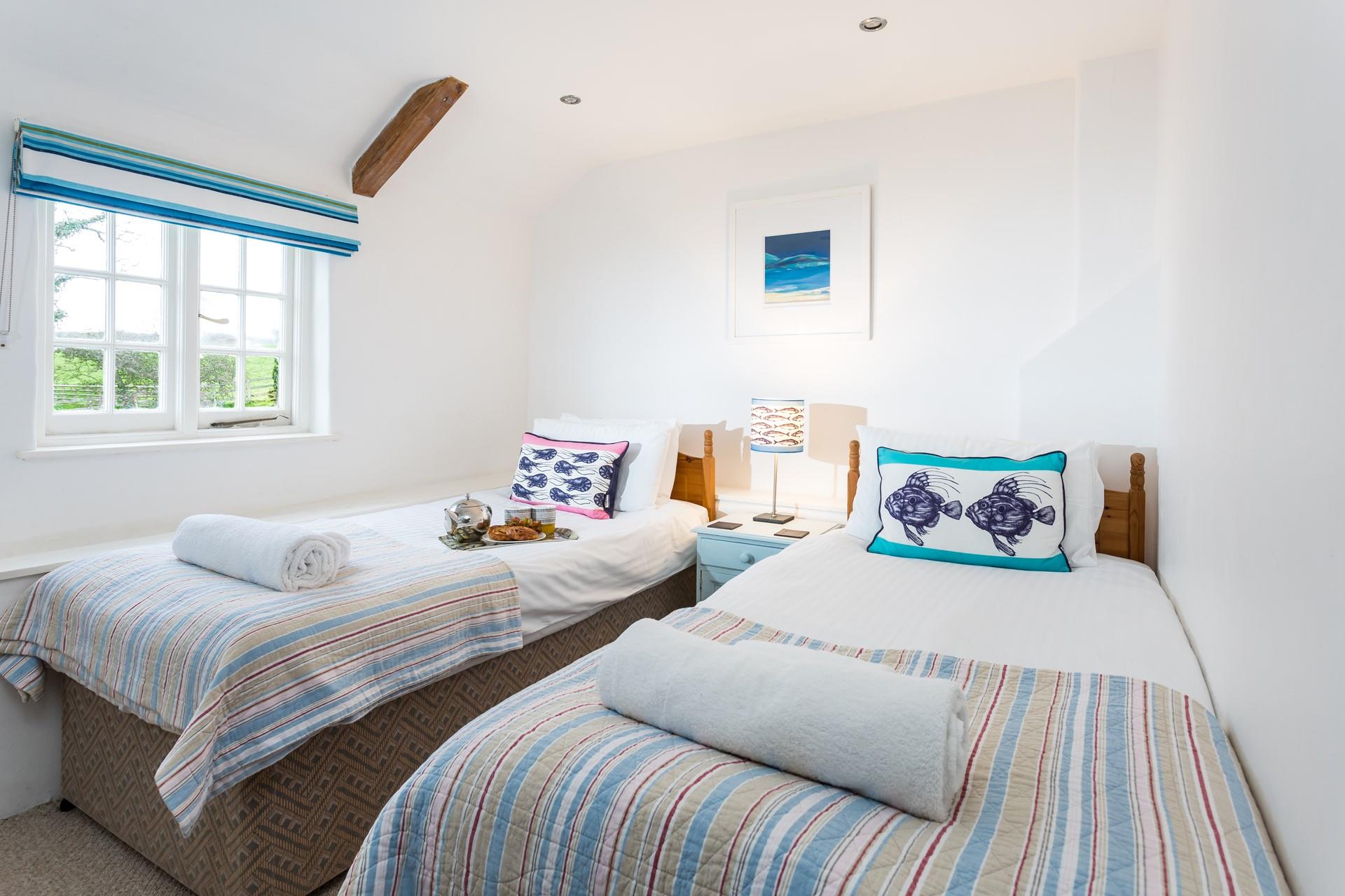 The colourful twin bedroom decor is a nod to the nearby coast.