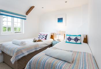 The colourful twin bedroom decor is a nod to the nearby coast.