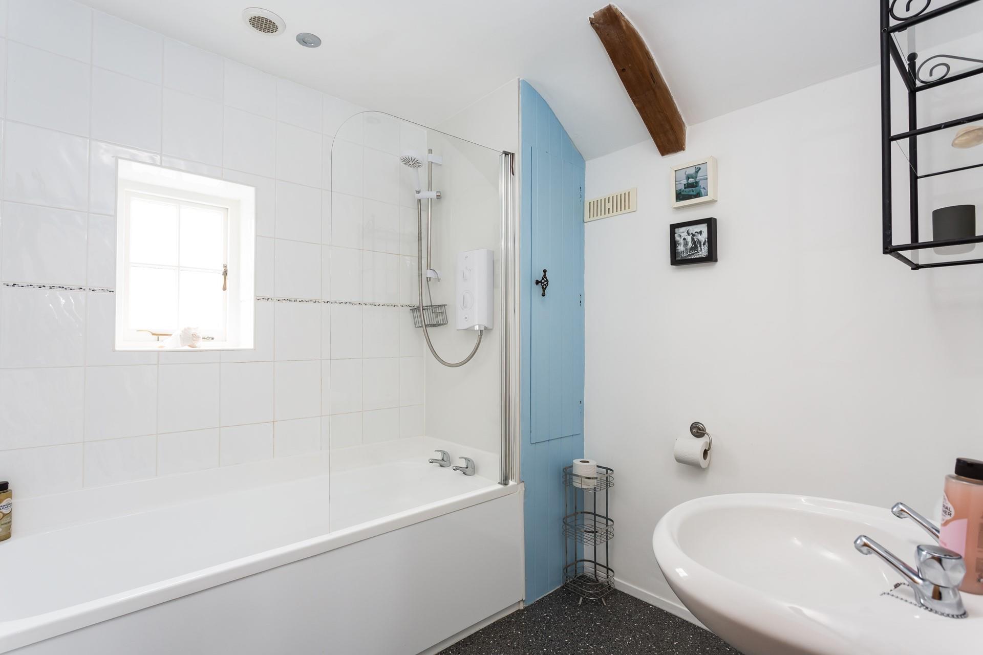 The family bathroom boasts a shower and bath.