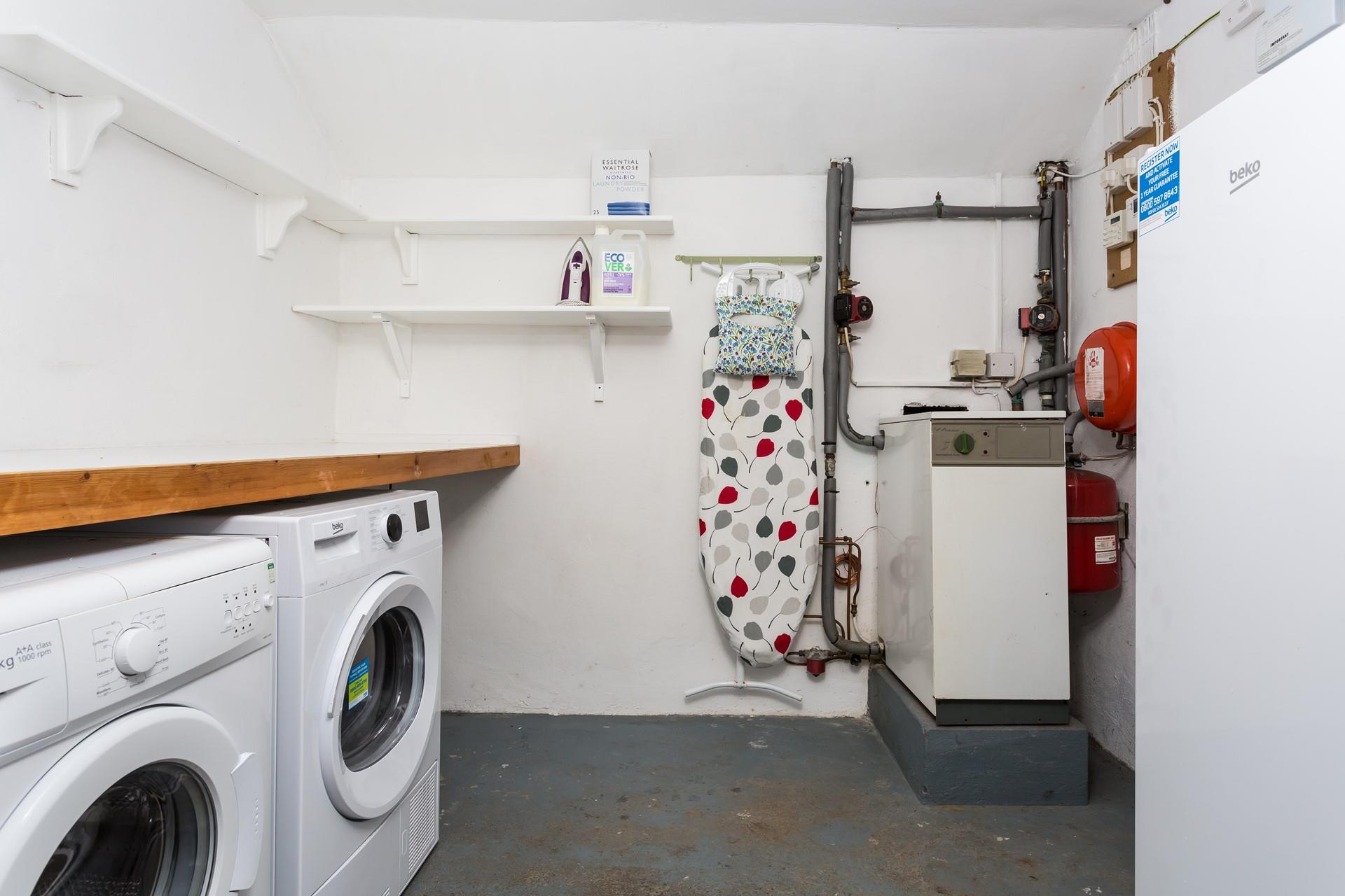 The utility has a washing machine and tumble dryer.