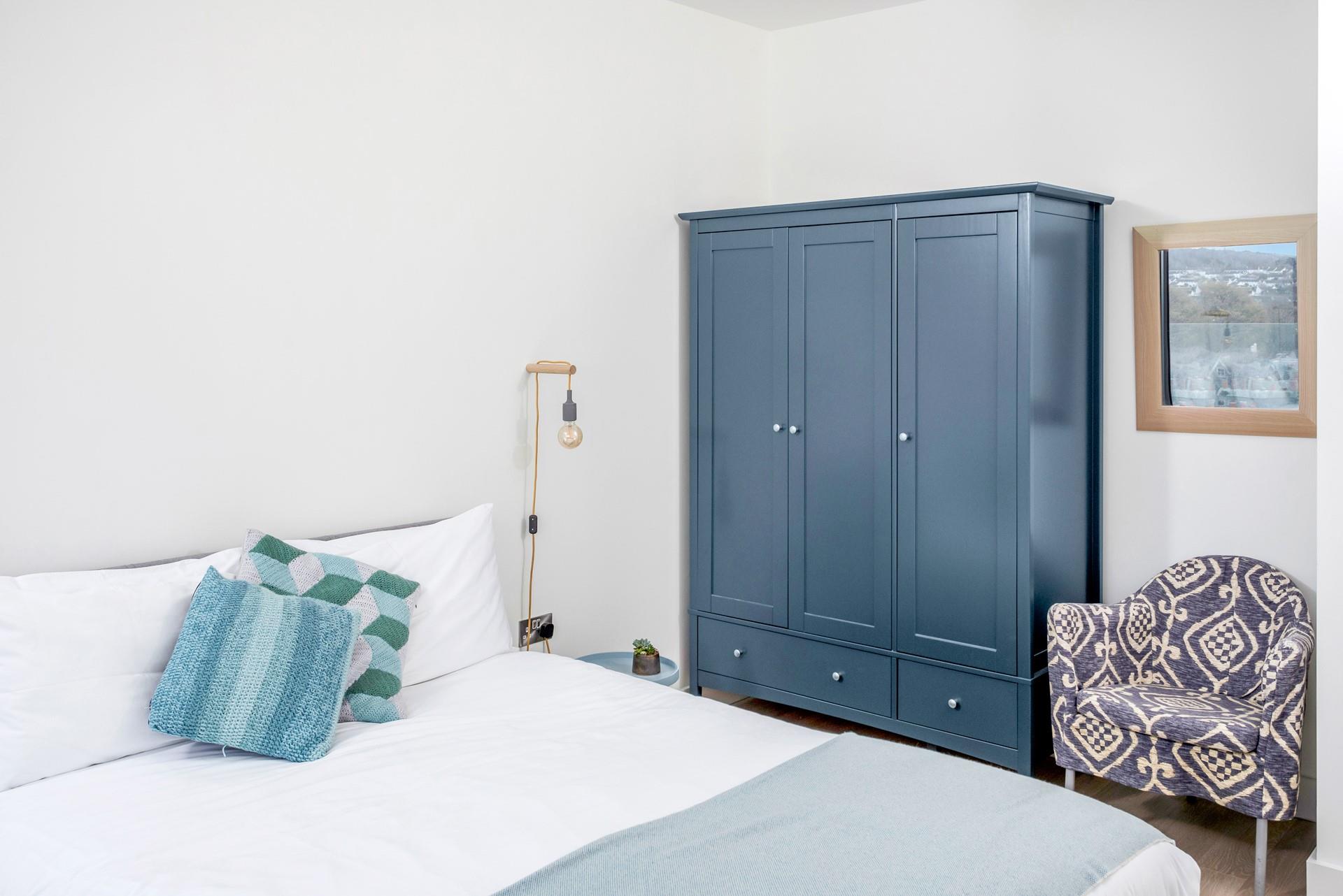 Calming blue tones in bedroom 2 create the perfect space to relax.