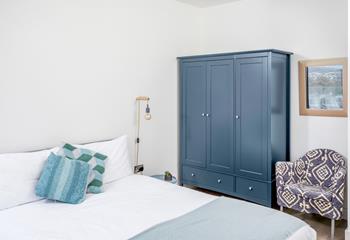Calming blue tones in bedroom 2 create the perfect space to relax.