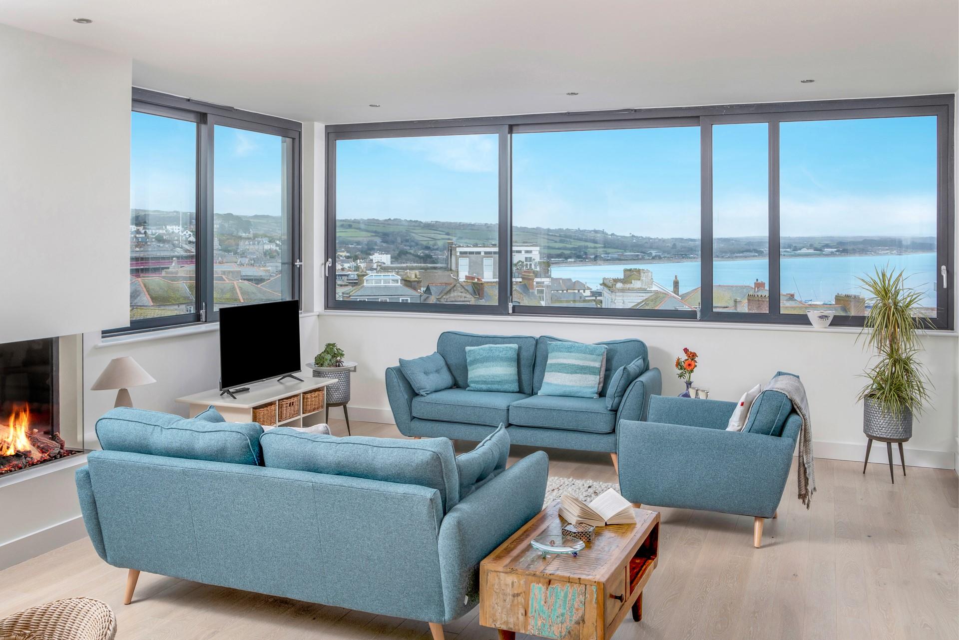 The apartment is filled with light from the windows.