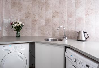 The utility room has a washing machine and tumble dryer.