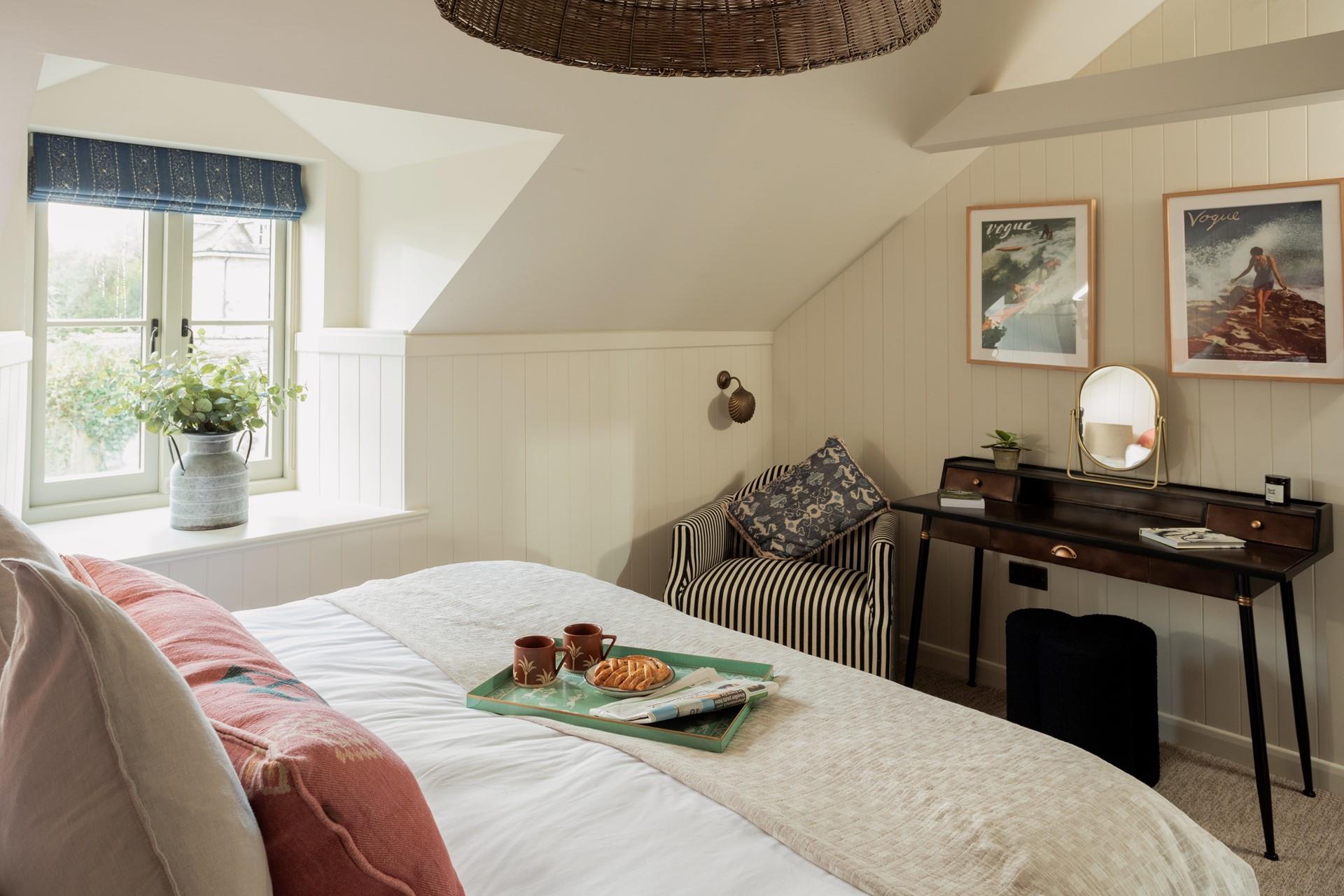 The cosy bedroom mixes cottage style with modern furnishings.