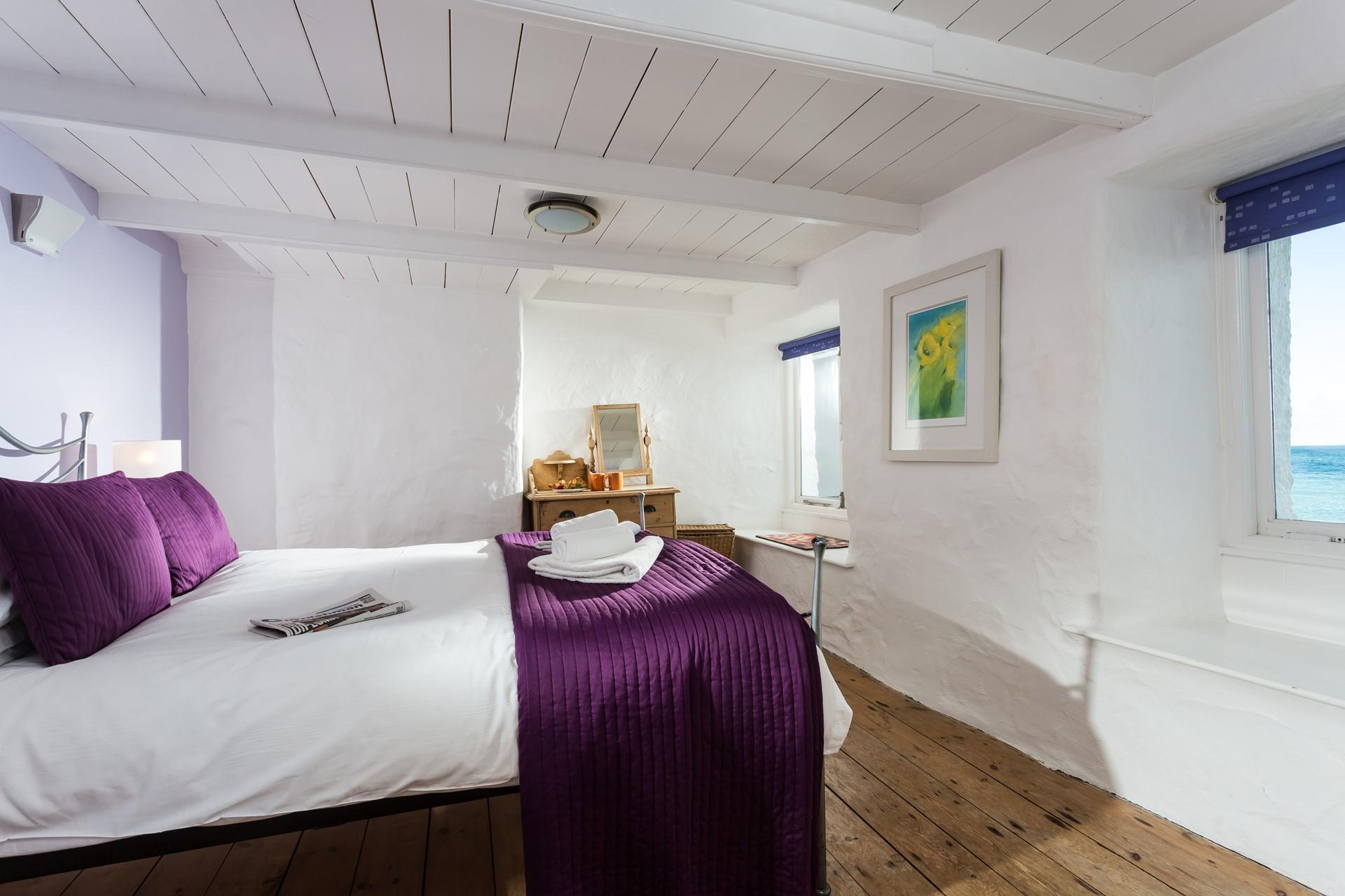 Soft sheets and fluffy white towels await in Bedroom 1.