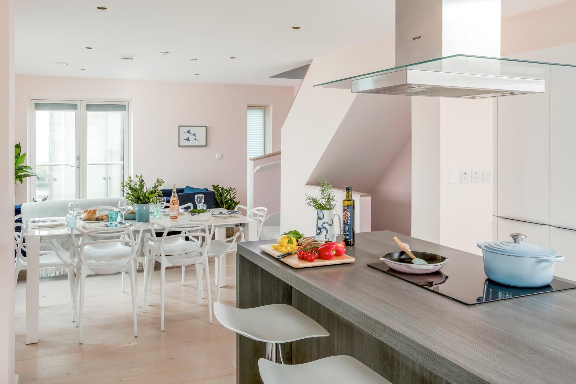 The open plan kitchen/dining space is light and tastefully decorated.