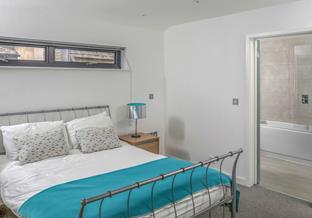 Climb out of bed and into the en suite to get ready for the day.