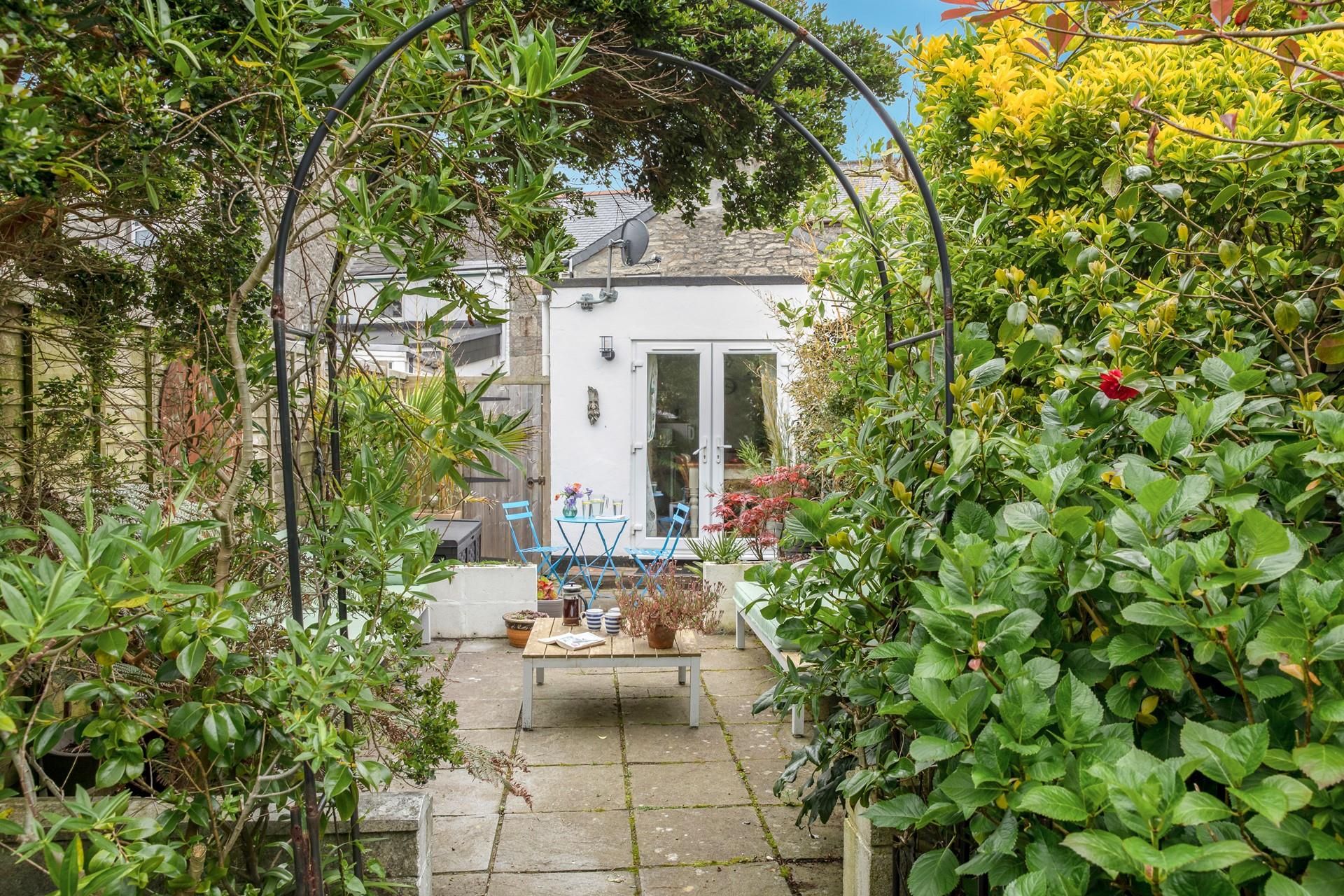 The leafy garden is perfect for sitting and soaking up the sun.