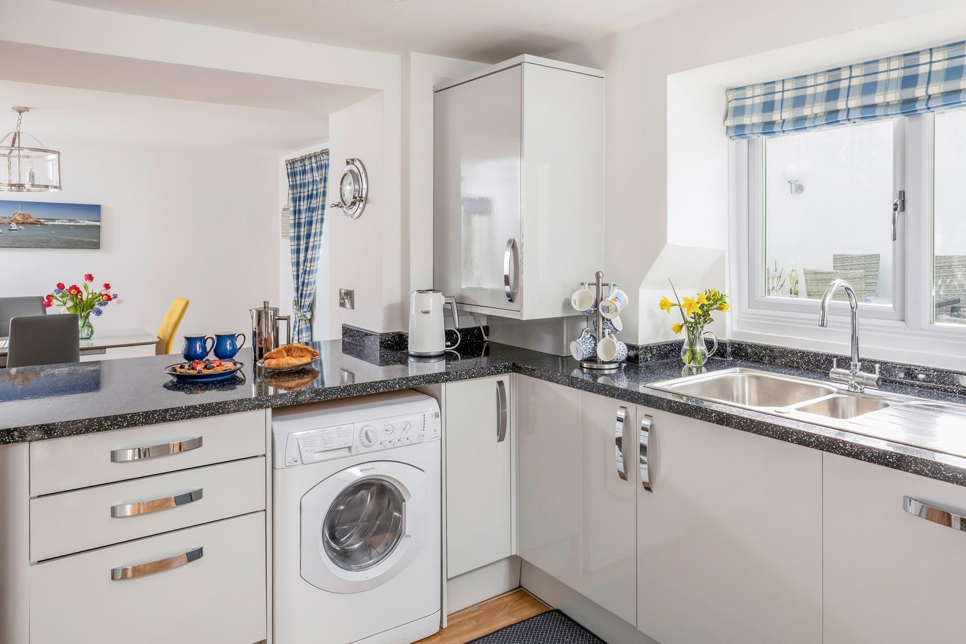The kitchen has all the appliances needed to prepare and cook meals.