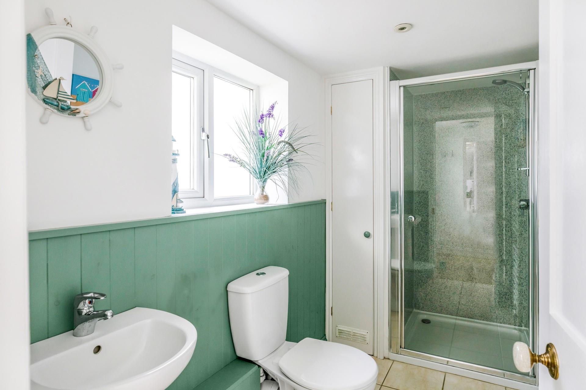 The downstairs shower room is perfect for washing off sandy toes after beach days.