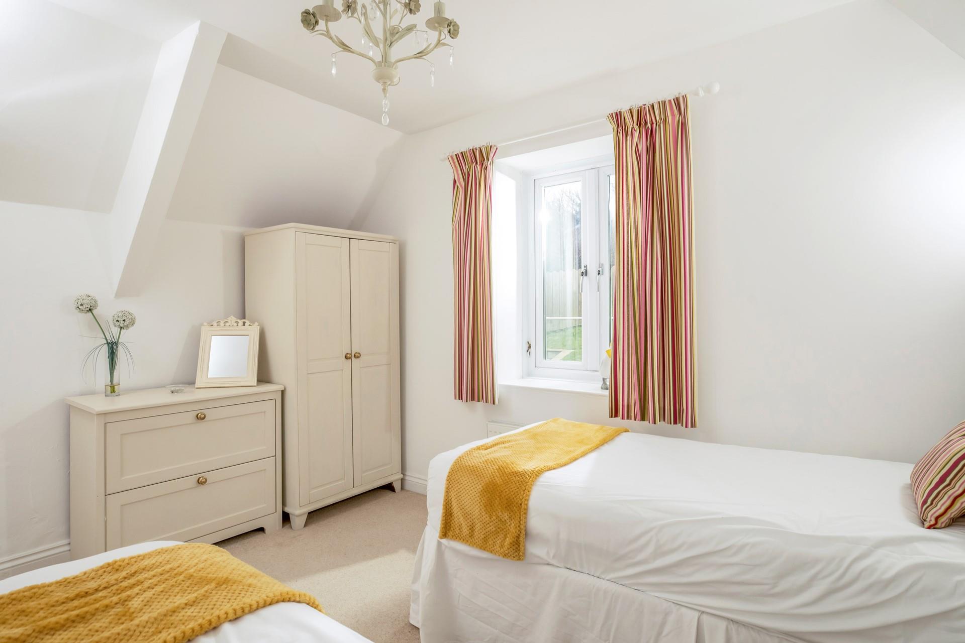 Bedroom 2 has a wardrobe and chest of drawers, plenty of space for holiday wear.