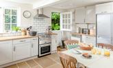 The kitchen is modern and well-equipped for cooking meals. - Thumbnail Image