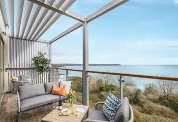 Sip a drink on the balcony enjoying the views over Carlyon Bay.