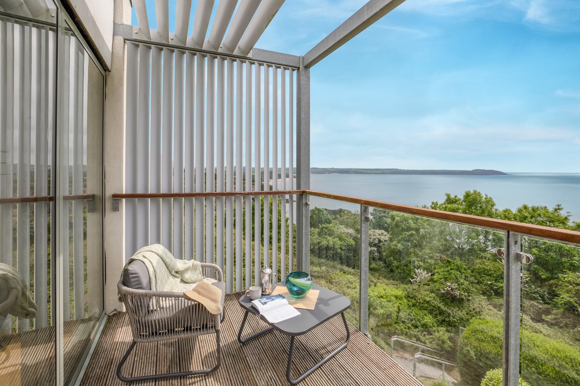 Sip a drink on the balcony enjoying the views over Carlyon Bay.