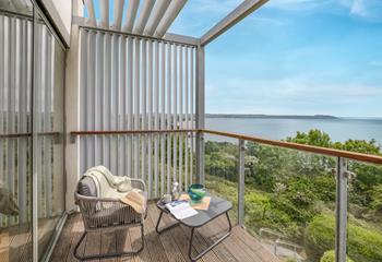 Sip a drink on the balcony enjoying the views over Carlyon Bay.