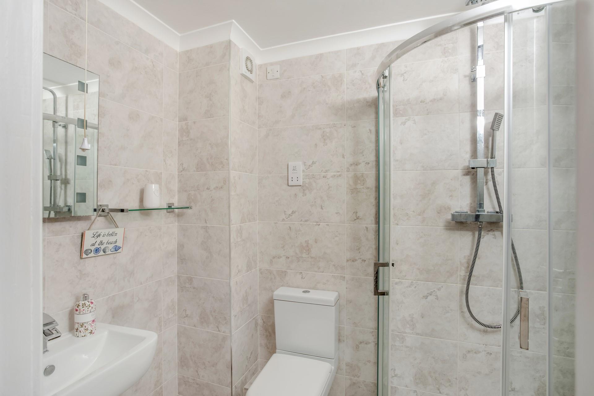 Wash off sandy toes in the shower after a day spent on Fistral beach.