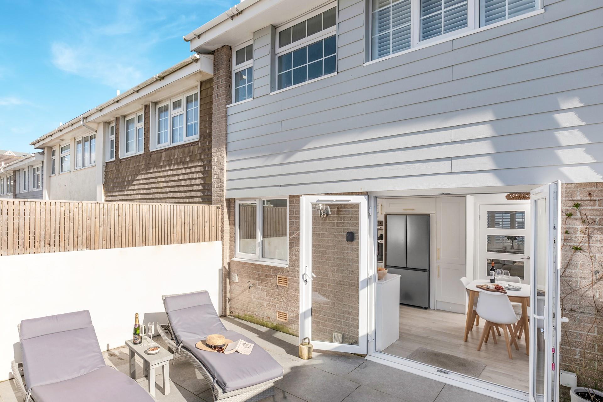 Relax on the loungers in the sun-soaked garden.