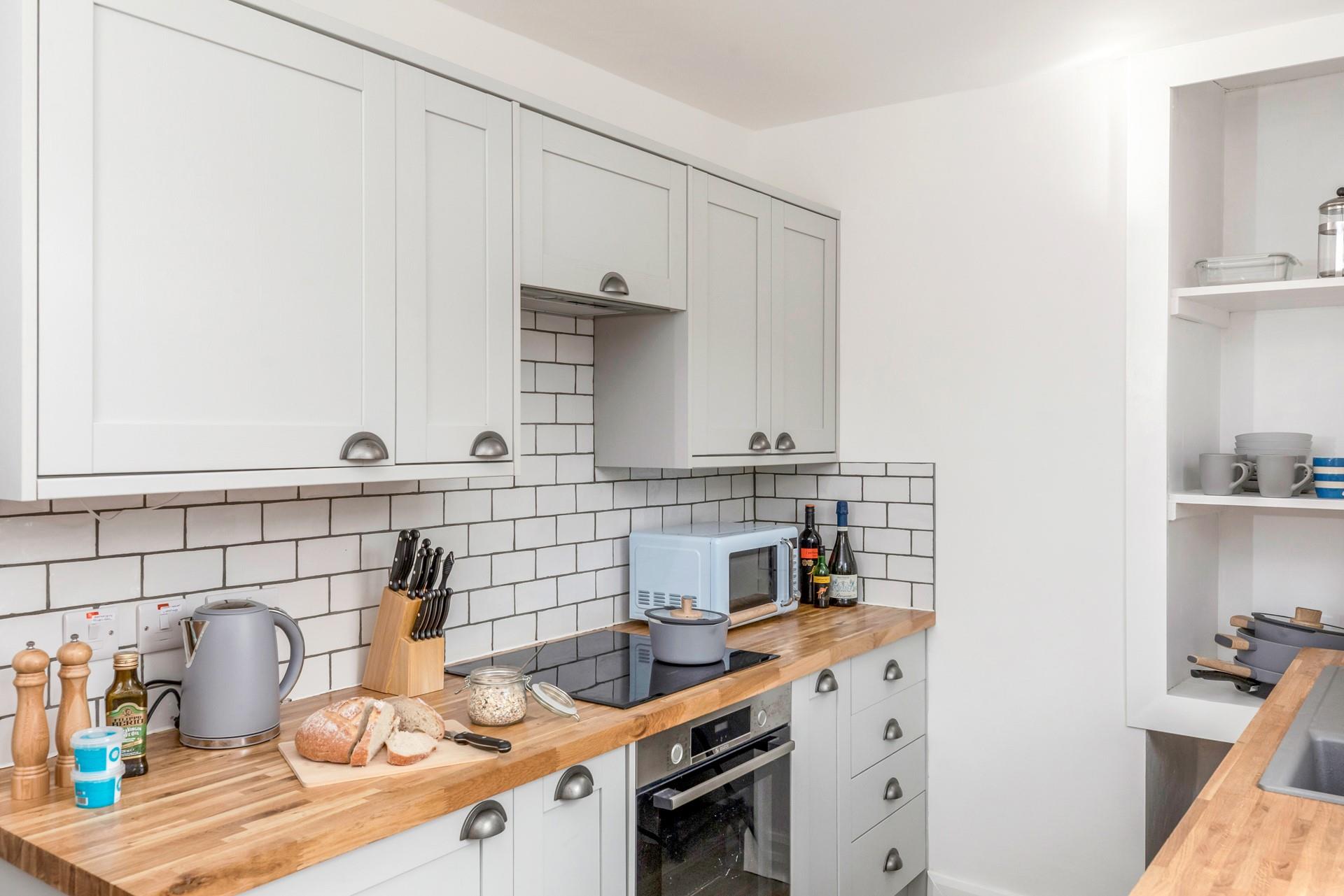 The kitchen is modern and fully equipped to prepare and cook a tasty meal.