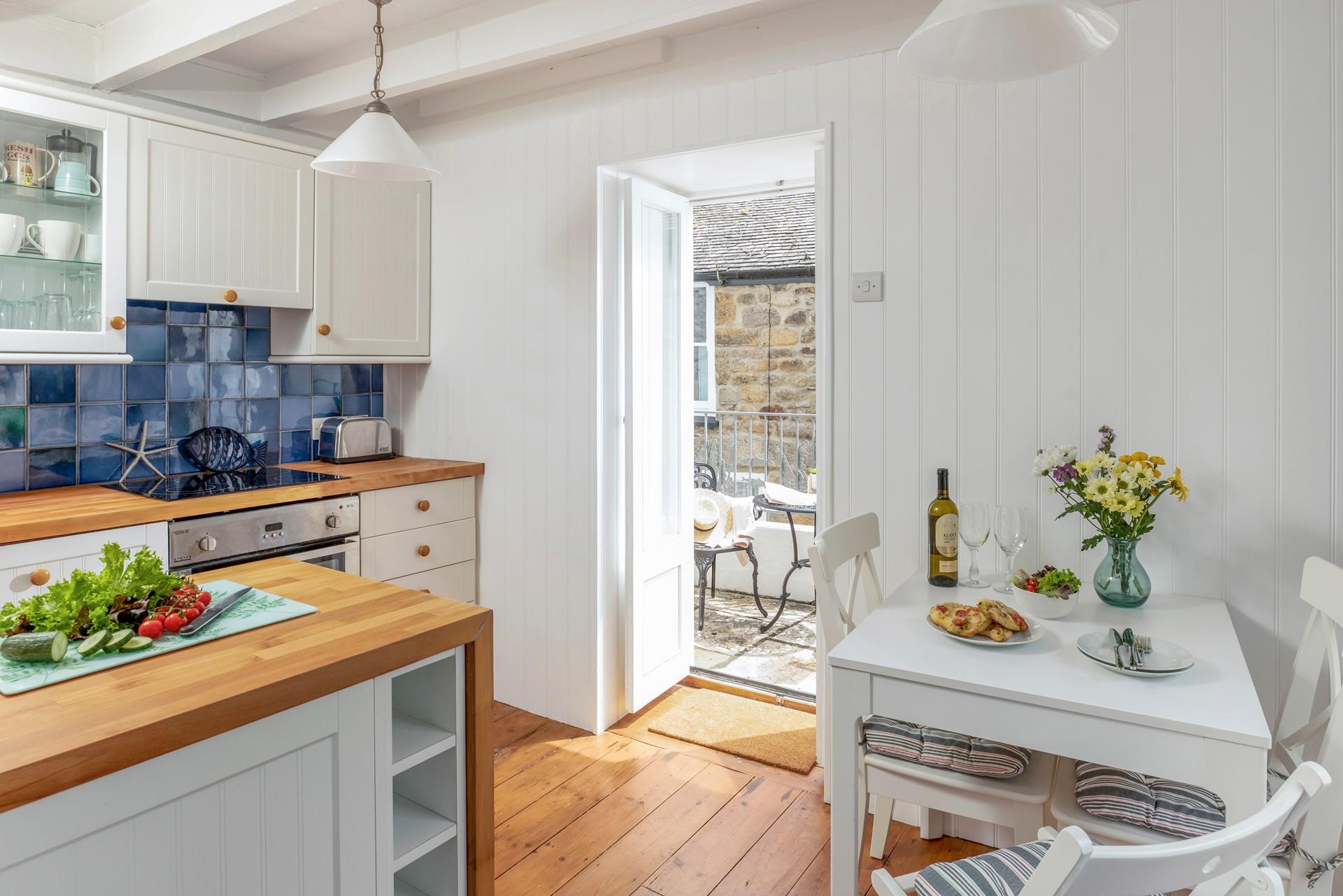 The open plan kitchen dining area leads to the courtyard for al fresco meals.