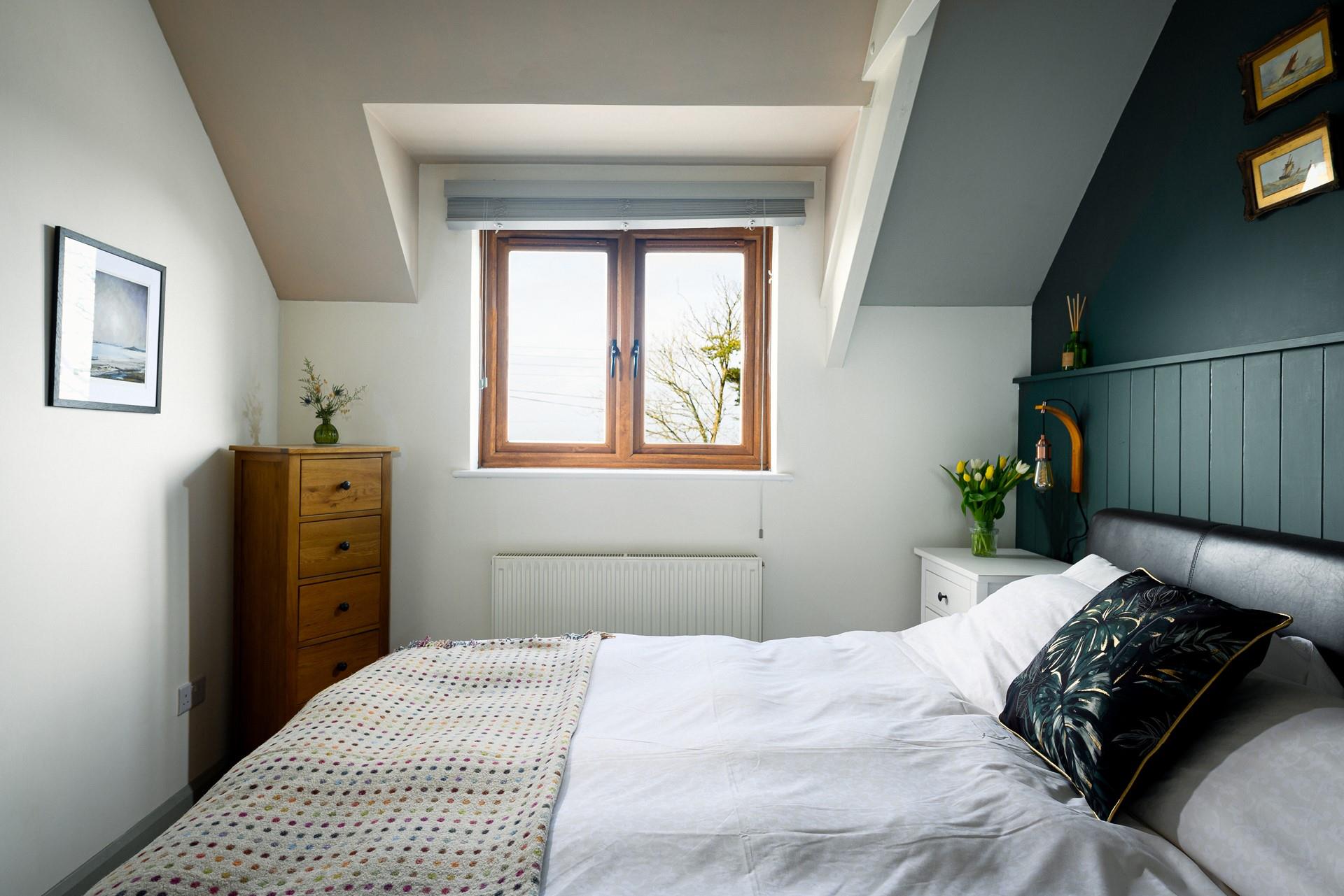 The comfortable bedroom has a super king size bed.