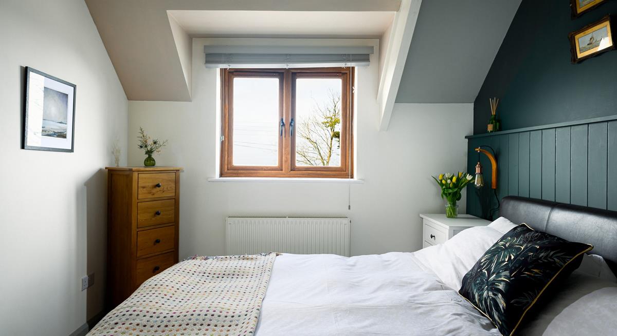 The comfortable bedroom has a super king size bed.