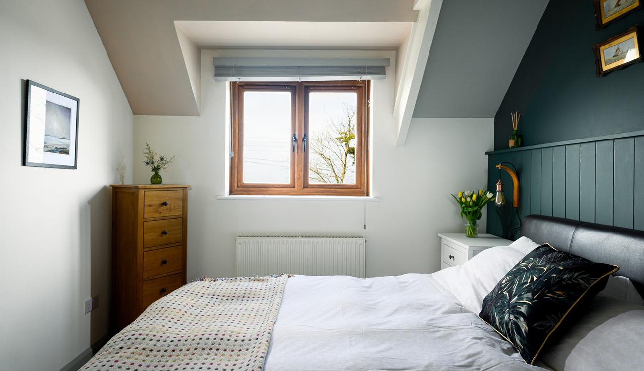 The comfortable bedroom has a super king size bed.