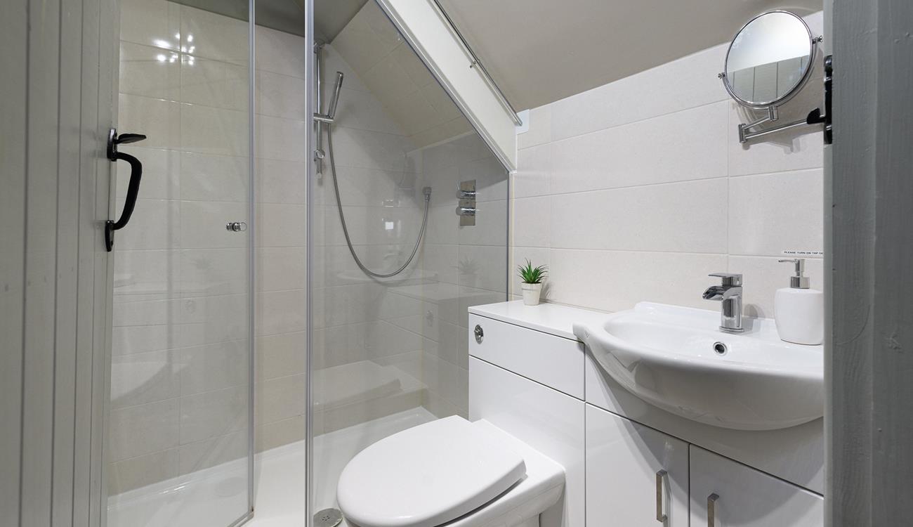 The en suite has a shower for washing off sandy toes after beach days.