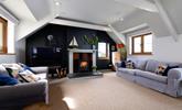 Light the woodburner and spend a cosy evening in the sitting room. - Thumbnail Image