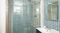 The family shower room has a delightful rainfall shower, perfect for rinsing off after a day on the sand.