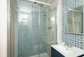 The family shower room has a delightful rainfall shower, perfect for rinsing off after a day on the sand.