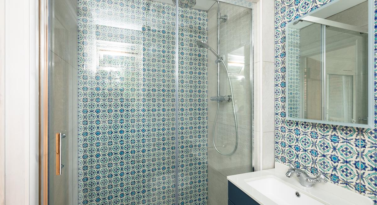The family shower room has a delightful rainfall shower, perfect for rinsing off after a day on the sand.