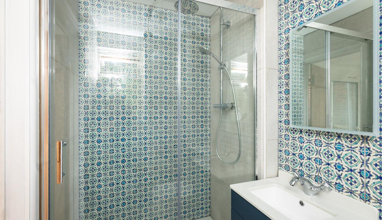 The family shower room has a delightful rainfall shower, perfect for rinsing off after a day on the sand.