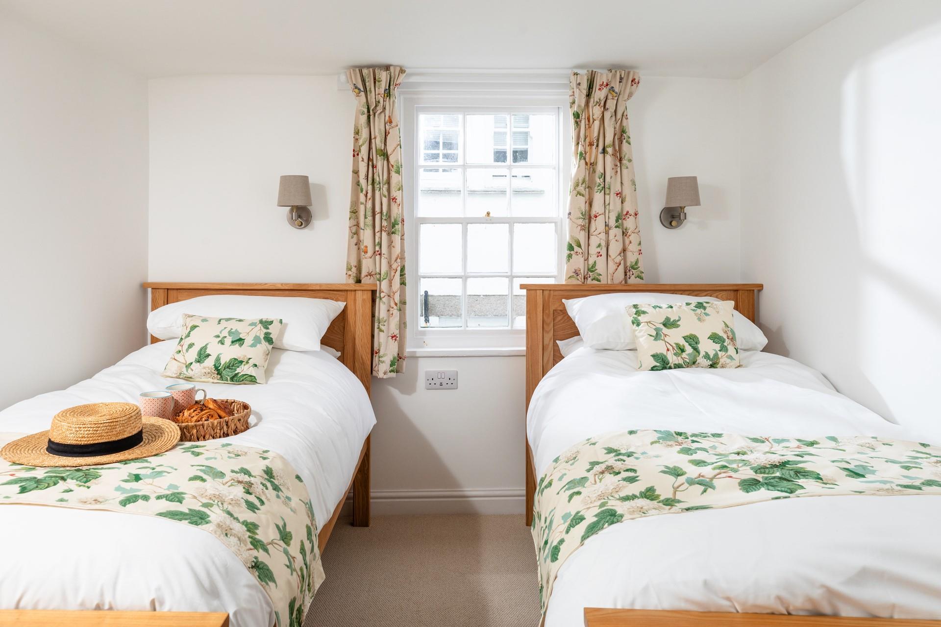 The pretty twin bedroom has a relaxing country-cottage feel.