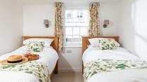 The pretty twin bedroom has a relaxing country-cottage feel.