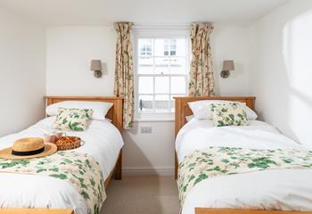 The pretty twin bedroom has a relaxing country-cottage feel.