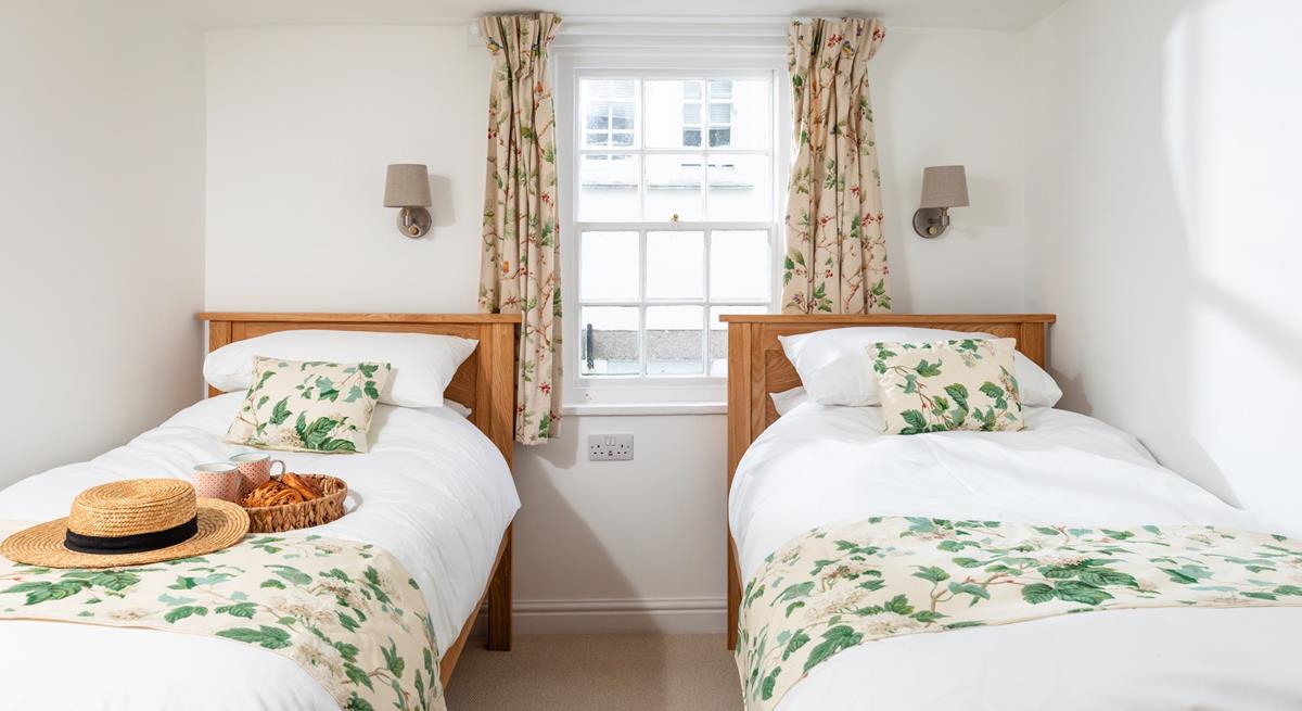 The pretty twin bedroom has a relaxing country-cottage feel.