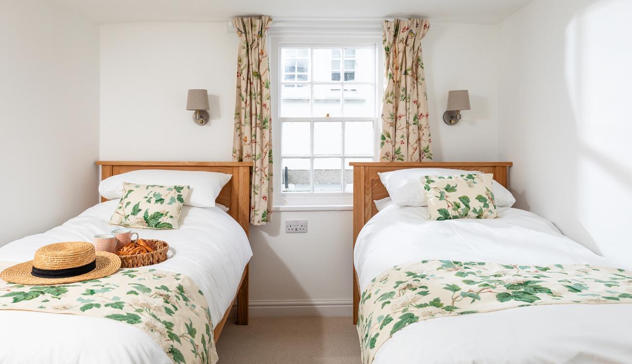 The pretty twin bedroom has a relaxing country-cottage feel.