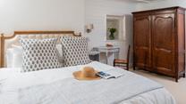 You'll drift off soundly in the classic cottage bedroom with plush mattress.