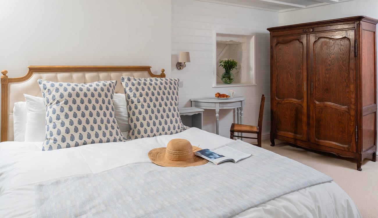 You'll drift off soundly in the classic cottage bedroom with plush mattress.